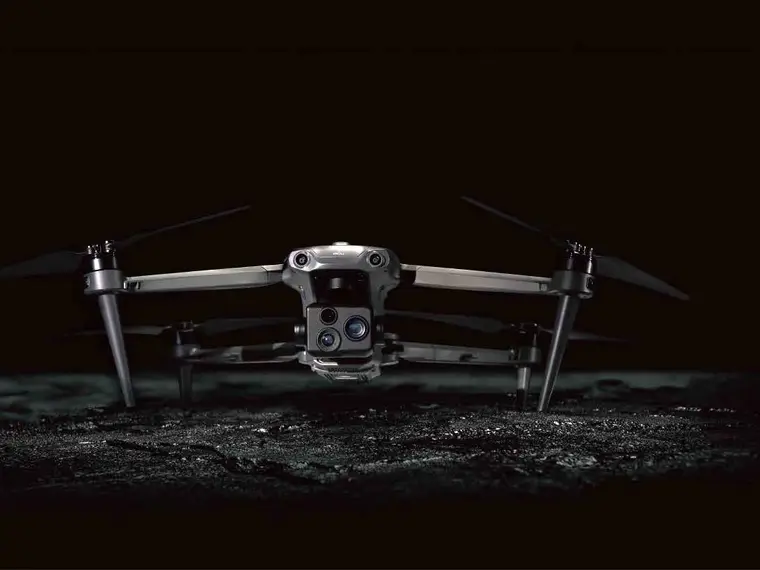 A P200-series drone with its quad-sensor camera, standing on dark ground