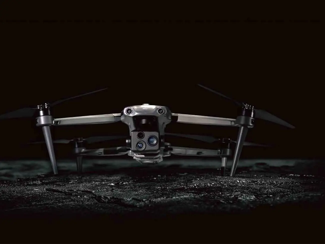 A P200-series drone with its quad-sensor camera, standing on dark ground
