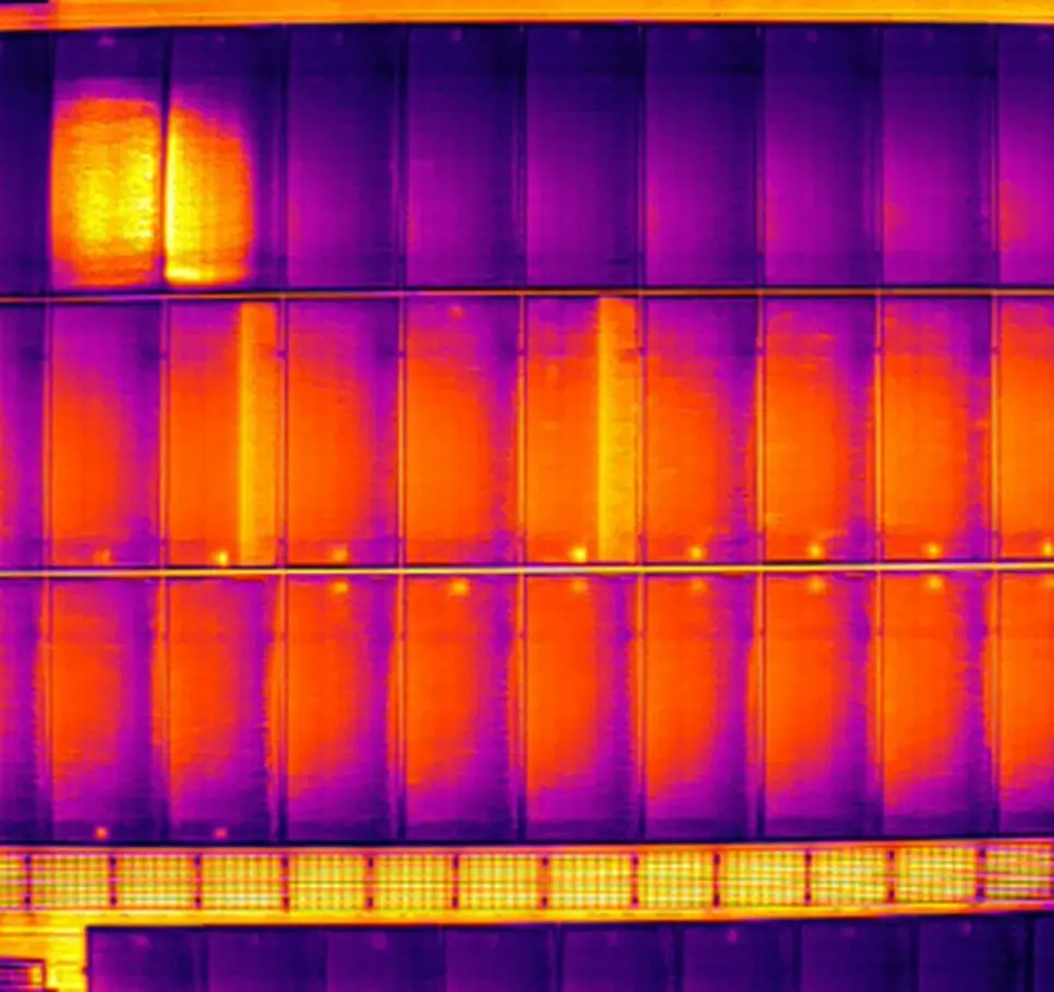 A thermal image of solar panels from a drone survey, one panel showing a hot spot
